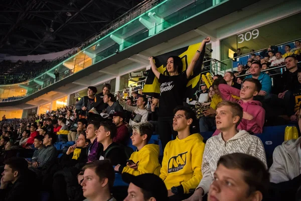 MOSCOW, RUSSIA - OCTOBER 27 2018: EPICENTER Counter Strike: Global Offensive esports event. Happy girl fan on a tribune at arena with team Natus Vincere flag. Cheering for her favorite team. — Stock Photo, Image