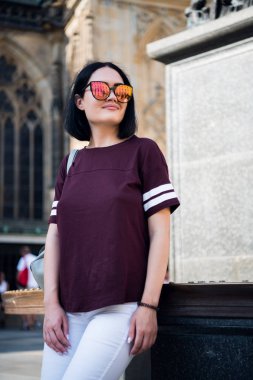 Moda gözlük ve bir t-shirt giyen genç şık kız. Soyut tarafına bakıyor. sokak moda kavramı.