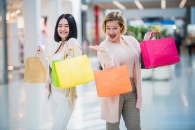 Ayakta ve alışveriş merkezi Galerisi'nde konuşurken kızlar