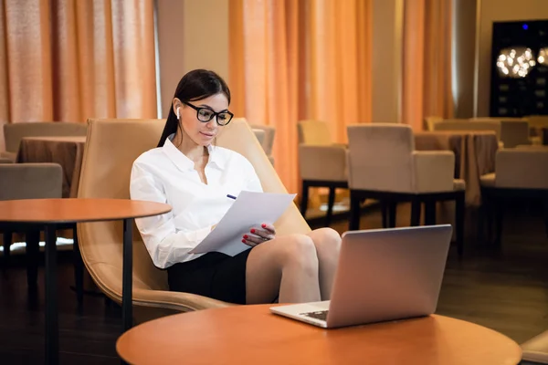 Retrato de cerca de la mujer casual usando su computadora portátil mientras está sentada en el sofá y trabajando . —  Fotos de Stock
