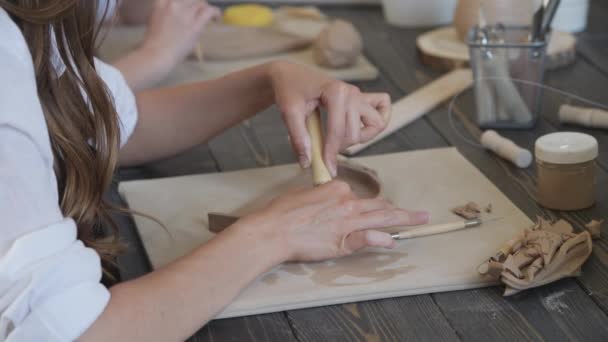 Közelkép egy fazekas mesterről, agyagvágó speciális szerszám. Női művész vágás egy fa hurok eszköz. — Stock videók