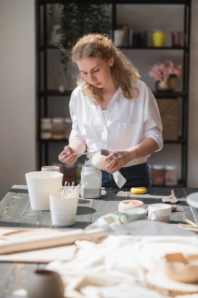 Κοντινό πλάνο μιας γυναίκας που κατασκευάζει κεραμικά και κεραμικά επιτραπέζια σκεύη στο εργαστήριο, δουλεύοντας με πηλό και γάνωμα. — Φωτογραφία Αρχείου