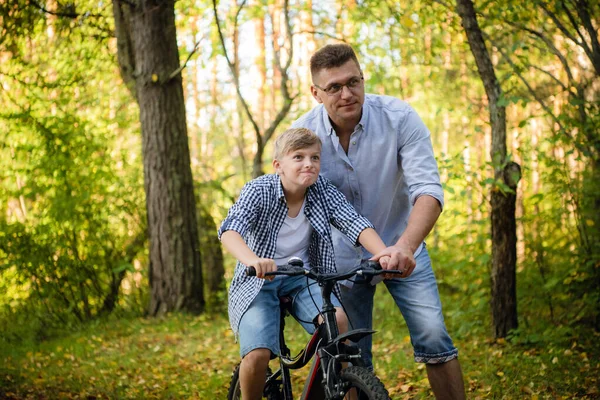 Père enseigne à son fils à faire du vélo — Photo