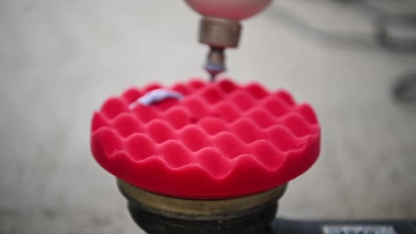 Slow motion closeup footage of professional worker applies special polishing paste or cream on polisher disc. Preparing to work on car surface refreshment removing scratches. — Stock Video