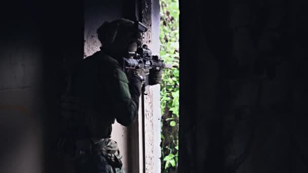 Soldat in Form hält ein Sturmgewehr in den Händen, checkt mögliche Feinde um die Ecke