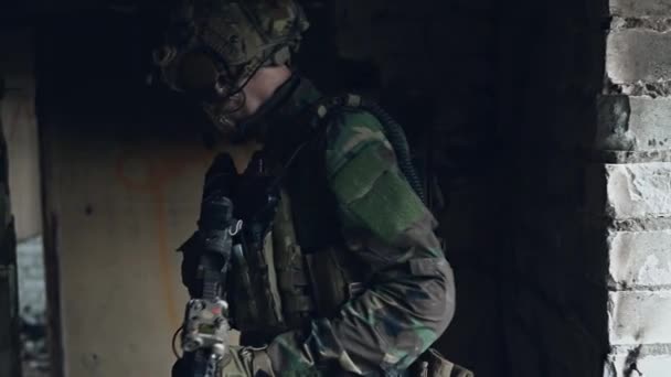 Військовослужбовці зі зброєю, що захищає будівлю. Солдат стоїть охоронець, що охороняє територію, яка озирається навколо . — стокове відео