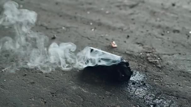 Smoke grenade thrown on the ground. Closeup of smoke grenade lying on a floor. — Stock Video