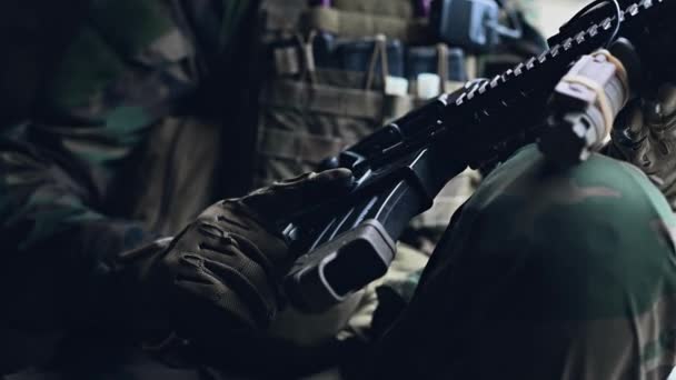 Weapon inspection while waiting on a spot. Military man checks his assault rifle preparing for operation. Close up view — Stock Video