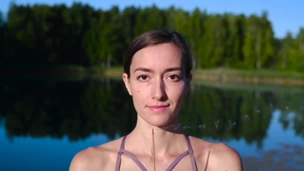 Yoga-Frauen in Sportkleidung meditieren und atmen an einem Sonnenaufgang in der Natur. Rauch vom Duftstab in den Händen. — Stockvideo