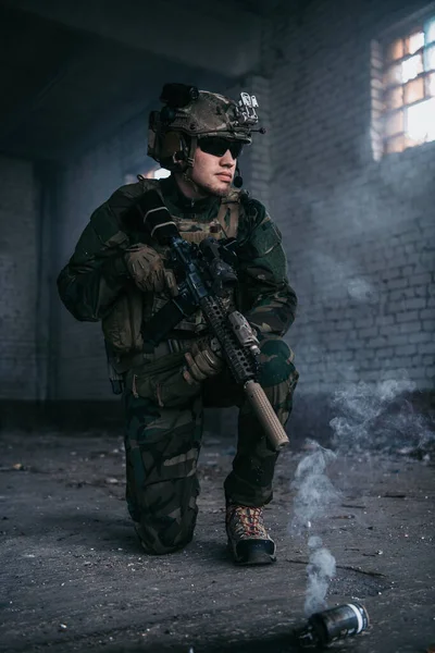 Military man during combat and smoke grenade on a ground. — Stock Photo, Image
