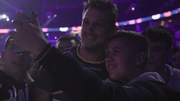 MOSCOW - 14th SEPTEMBER 2019: esports event of a Counter Strike game. Gamer professional Zeus with fans on a tribune at tournaments arena. Making pictures and giving autographs to his rooters. — Stock Video