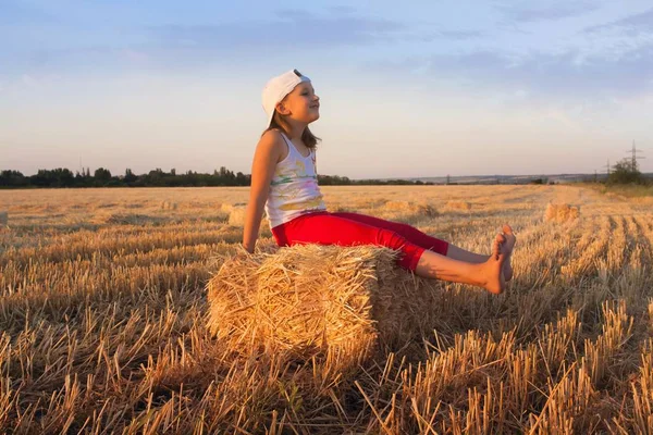 Girl playing in the sun . Loving the free . Inner world of the child . Meditation as way of life . Relaxation in the fresh air . Portrait of the happy beautiful young woman . in the field of wheat . happy