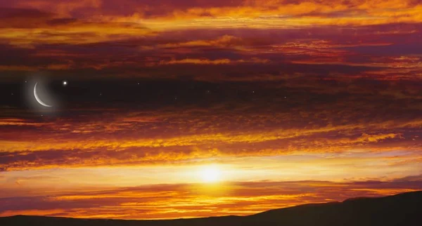 Crescent moon with beautiful sunset background .  Light from sky . Religion background . Red sunset and moon . Against the background of clouds . beautiful sky . Yellow and pink clouds . Sunset and new moon . Prayer time . Generous Ramadan