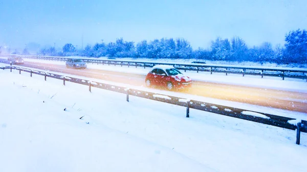 Snow landscape . Winter forest driving . highway in winter, heavy snow storm