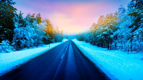 Snow landscape . Winter forest driving . highway in winter, heavy snow storm