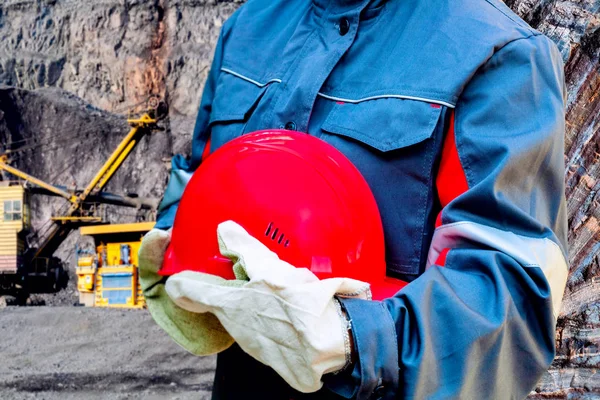 Heavy industry . Hard work .  red protective helmet . Safety helmet . the worker in special clothes