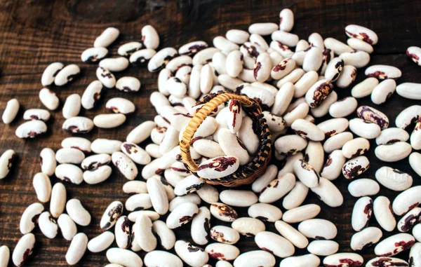 White beans . Colorful variety mixed beans . on a wooden table.