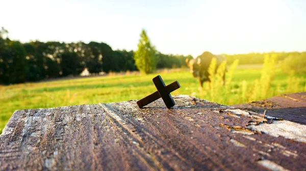 Wooden cross on background . Closeup of wooden Christian cross