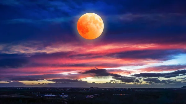 Eclipse of the moon in clouds sky, natural phenomenon