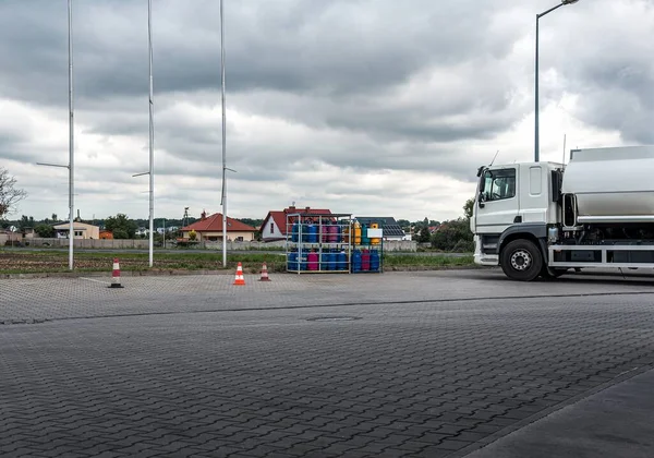 fuel truck at gas station, delivery of dangerous goods