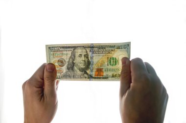 Sahte para ışık kontrol. Elini cama 100 dolar. Filigran üstünde yeni yüz dolarlık banknot olup olmadığını denetleyin. translucence Amerikan para birimi.