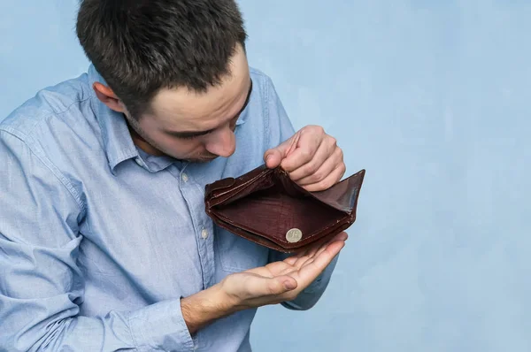 Business person holding empty purse in his hand. Stock Photo by  stockfilmstudio