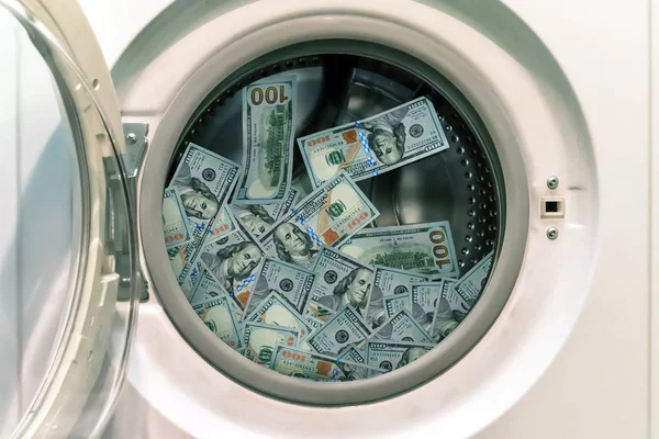 Close-up Of Pile Of Dirty Money Placed In Washing Machine. concept of laundering illegal money. launder money. black market