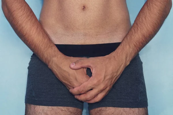 Handsome man is using his hands closing his penis. Attractive man gets painful of mind, he can t has sex. He get erectile dysfunction. He feels unhappy and depressed. He feels shy and lost confident — Stock Image Handsome Man Using His Hands Closing His Penis Attractive Man Stock Picture