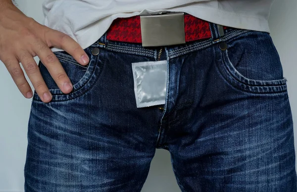 Man Condom His Legs Safe Sex Man Blue Jeans Hand — Stock Photo, Image