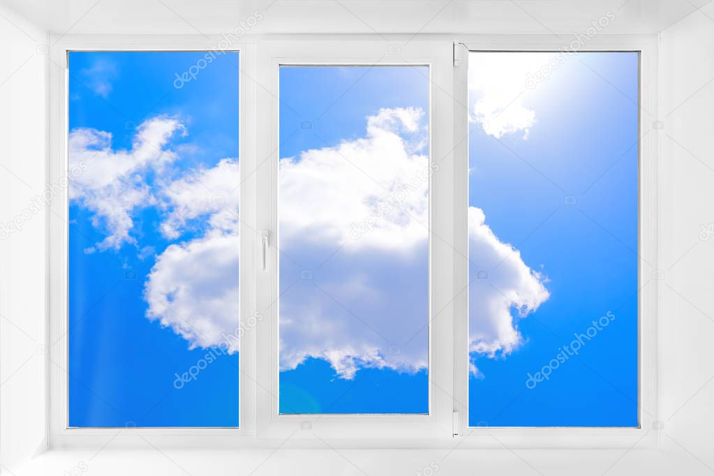 Clean window with an empty sill and blue sky. White plastic three-chambered three-sided box