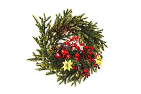 Christmas wreath of cones, spruce branches and berries, New Year\'s decorations. Isolated, white background. beautiful spruce wreath with red flowers, balls, berries and stars.