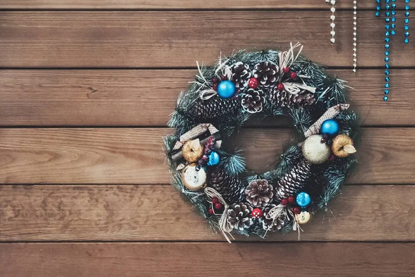 Christmas wreath of cones, spruce branches and berries, New Year's decorations. beautiful spruce wreath with cones, balls and fruit