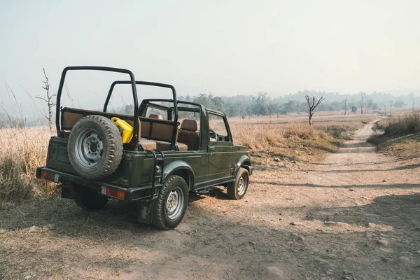 Open-top car on the field road. Competition off road and rough terrain. The Safari vehicles on the background of autumn road and the steppe. field road