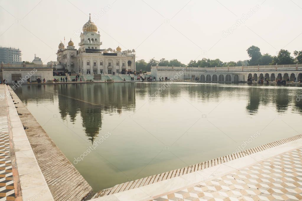 Gurudwara Bangla Sahib Sik temple in Delhi India. A sacred place of sikhi religion. The reflection of the temple in a clean mirror water