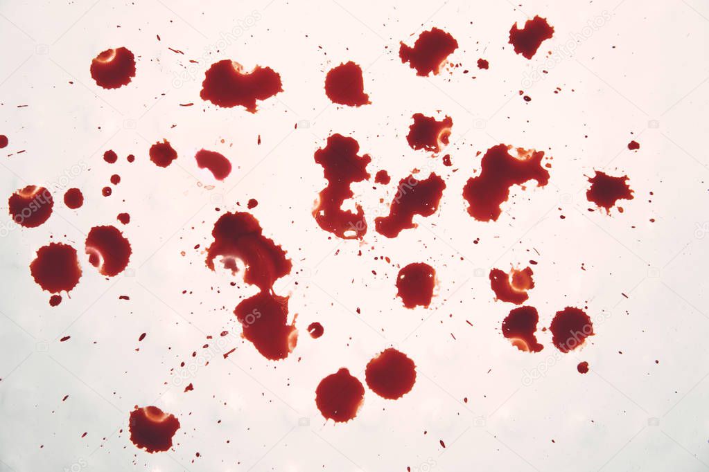 Blood-stained white surface. Disgusting view to the blood drops on whiteness. Bloody spits on white. Red spittles dripple on light background. Human wound. Bleeding research in medical laboratory