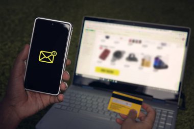 Adam shooping Web sitesi üzerinden dizüstü online ve kredi kartı elinde tutan smartphone bir kısa mesaj aldım. E-ticaret online bankacılık hizmetini kullanarak kavramı. İnternet satın almak için ödeme.