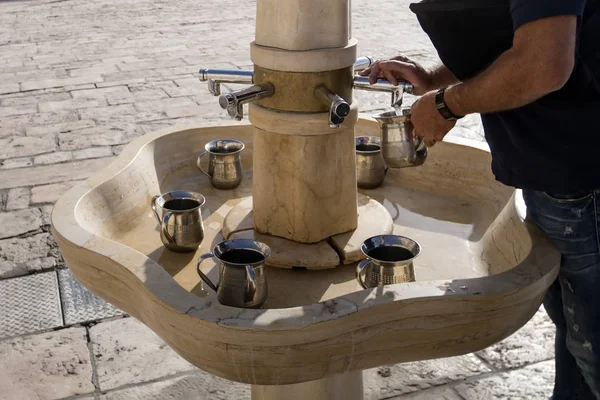 Kranen met water en speciale ritueel Cups voor het wassen van de handen naast de Klaagmuur in Jeruzalem. Israël. mensen wassen hun handen — Stockfoto