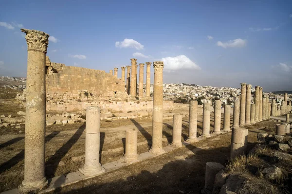 Temple in the Ancient Roman city of Gerasa, modern Jerash, Jordan. Old columns of ancient buildings on the blue sky. Ancient Roman sights in the Mediterranean.