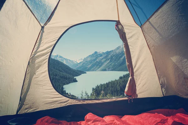 Camping tent with lake background. Beautiful mountain landscape in the Altai mountains. Lake kucherlinskoe. Siberia. Russia