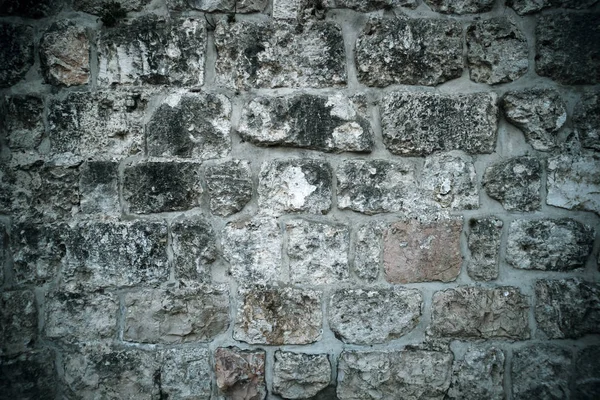 Fondo urbano, gris arruinado antiguo muro de ladrillo. Estructura de ladrillo antiguo. Parte del edificio antiguo. Antiguos tiempos. Historia y arqueología . — Foto de Stock