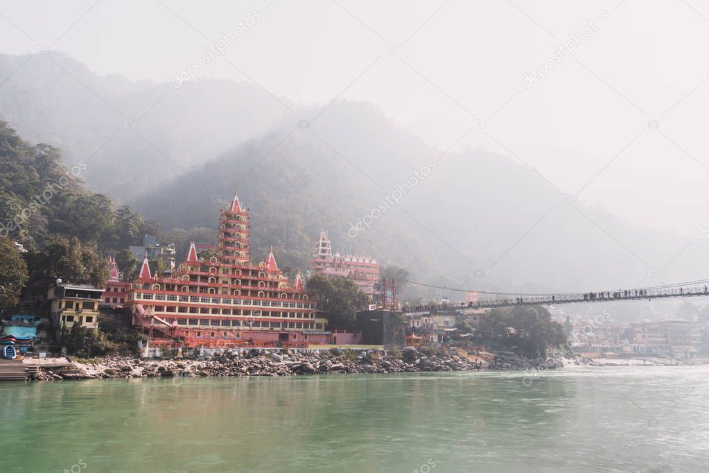 Unidentified People crossing Laxman Jhula footbridge on river Ganga