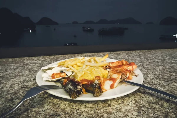 seafood dinner at restaurant to the sea. Vietnam ha long Bay night, nighttime, tonight.