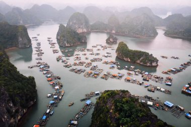 Aerial view of floating villages around Cat Ba islands. Cat Ba is the largest of the 366 islands, which make up the southeastern edge of Ha Long Bay in Vietnam clipart