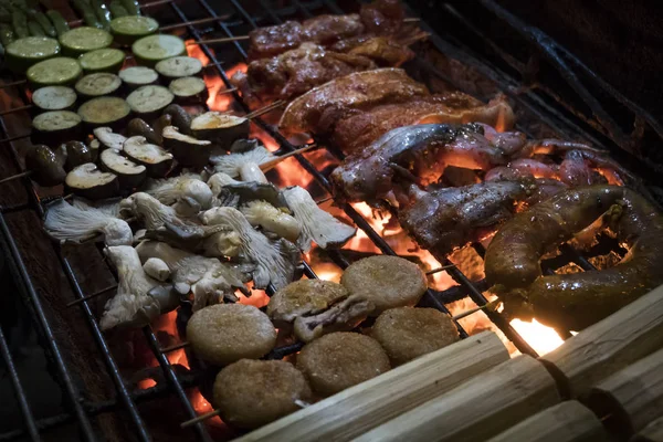 vegetables, mushrooms, frog, cooked on an open fire in the street. street Vietnamese food. Traditional Asian food.