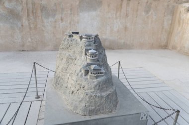 A miniature model of the summer palace of King Herod in zelot fortress Masada, Israel. View of the model of the mountain with the palace built on its top. Arhitecture of past times. Museology clipart