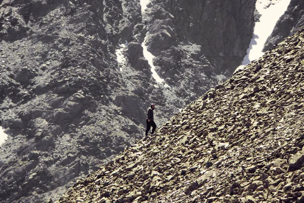 man climbing steep mountain. Good image for adventure, struggle and success story photo.