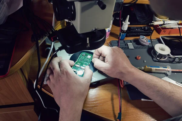 Close-up photos showing process of mobile phone repair