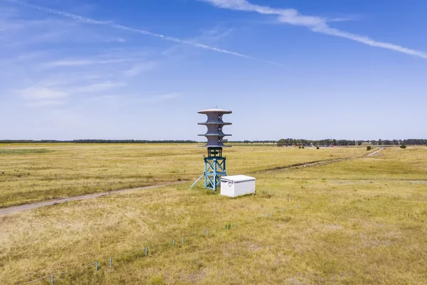 Renewable energy source. Windmill against the blue sky. Electric eco-friendly energy. Windmills for electric power production