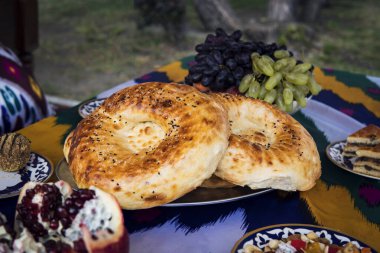 Uzbek restaurant bread. freshly baked tortilla on traditional table clipart
