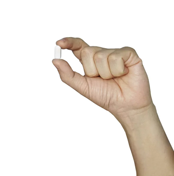 Handhållning, piller mellan tumme och pekfinger isolerad på vit bakgrund. vitt piller i handen. — Stockfoto